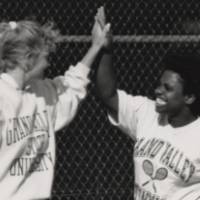 Two students high fiving.
